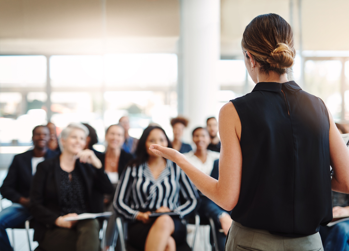 Woman teaching adults in classroom