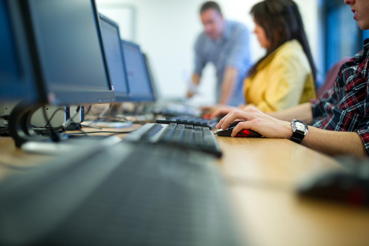 Photo of three people working on computers