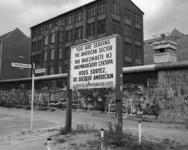 black and white photo sign and building behind the Berlian wall